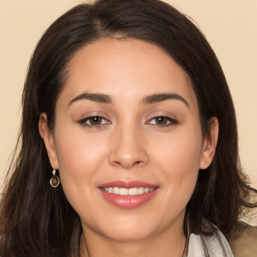 Joyful white young-adult female with long  brown hair and brown eyes