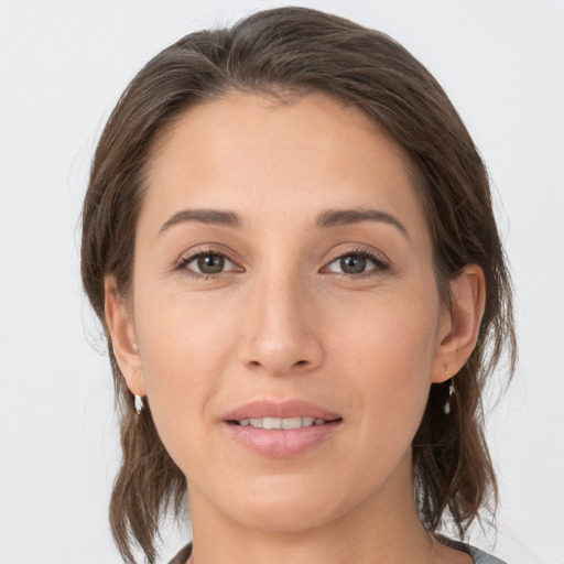 Joyful white young-adult female with medium  brown hair and grey eyes