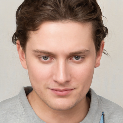 Joyful white young-adult male with short  brown hair and blue eyes