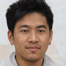 Joyful asian young-adult male with short  black hair and brown eyes