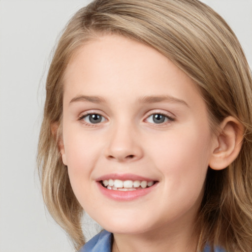 Joyful white child female with long  brown hair and blue eyes