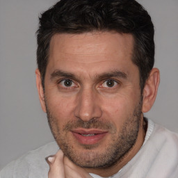 Joyful white adult male with short  brown hair and brown eyes