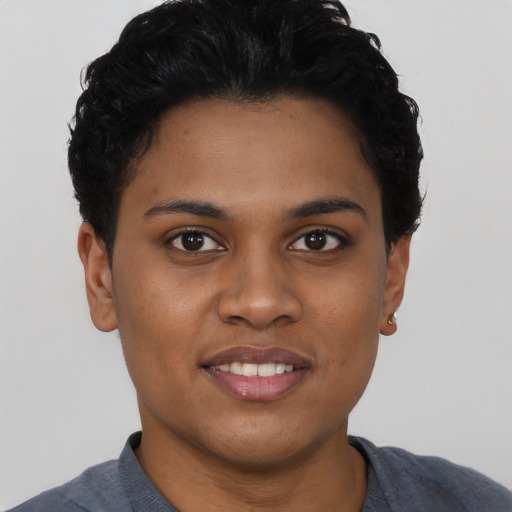 Joyful black young-adult female with short  black hair and brown eyes