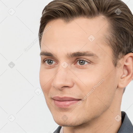 Joyful white young-adult male with short  brown hair and brown eyes