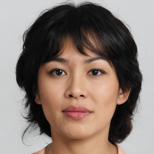 Joyful asian young-adult female with medium  brown hair and brown eyes