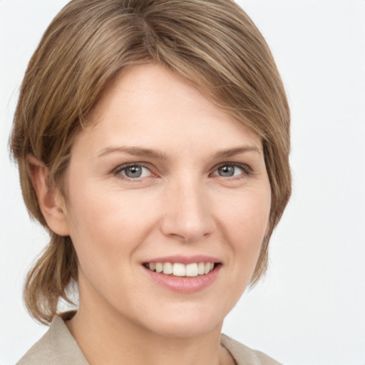 Joyful white young-adult female with medium  brown hair and grey eyes