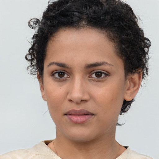 Joyful latino young-adult female with short  brown hair and brown eyes