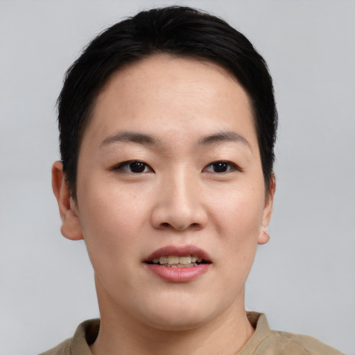 Joyful asian young-adult female with short  black hair and brown eyes