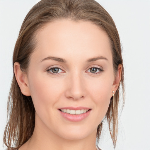 Joyful white young-adult female with long  brown hair and grey eyes