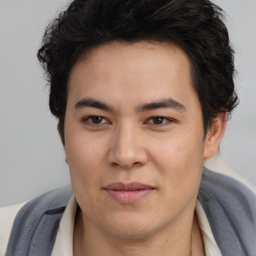 Joyful latino young-adult male with short  brown hair and brown eyes