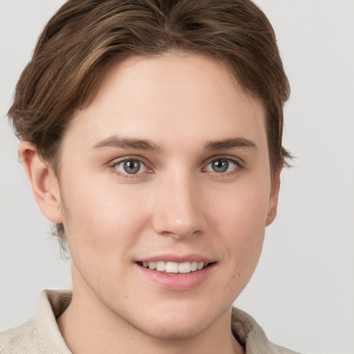 Joyful white young-adult female with short  brown hair and grey eyes