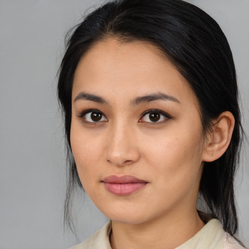 Joyful asian young-adult female with medium  brown hair and brown eyes