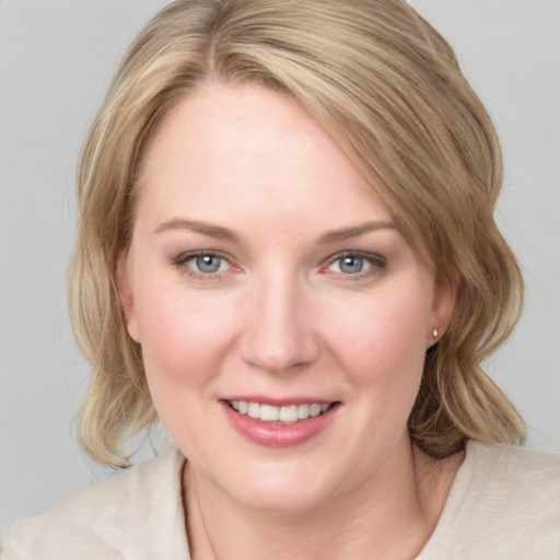 Joyful white young-adult female with medium  brown hair and blue eyes