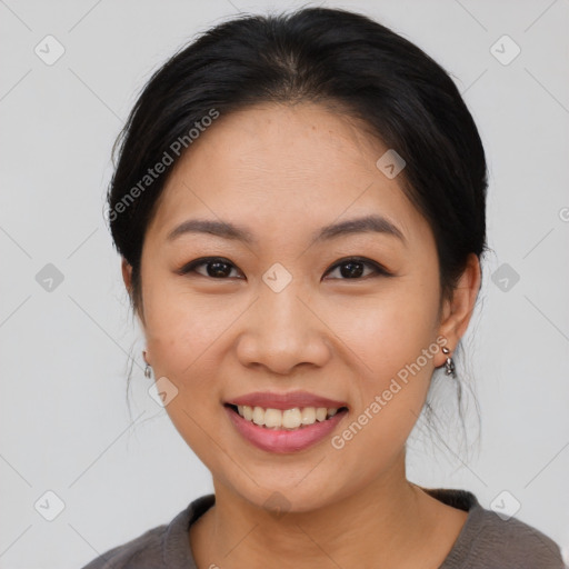 Joyful asian young-adult female with medium  black hair and brown eyes