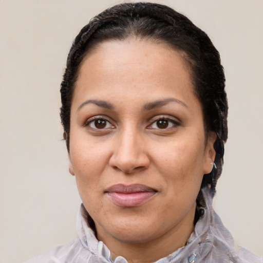 Joyful latino adult female with short  brown hair and brown eyes