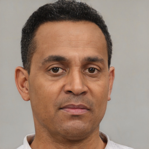 Neutral latino adult male with short  brown hair and brown eyes