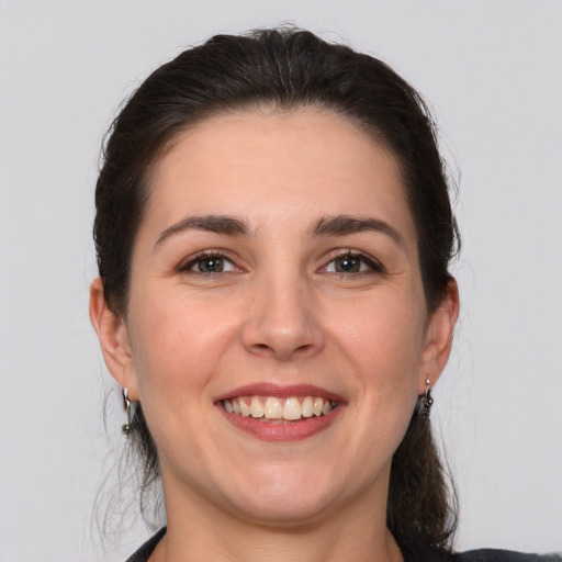 Joyful white young-adult female with medium  brown hair and brown eyes