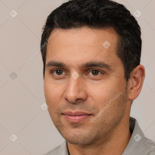 Joyful white young-adult male with short  black hair and brown eyes