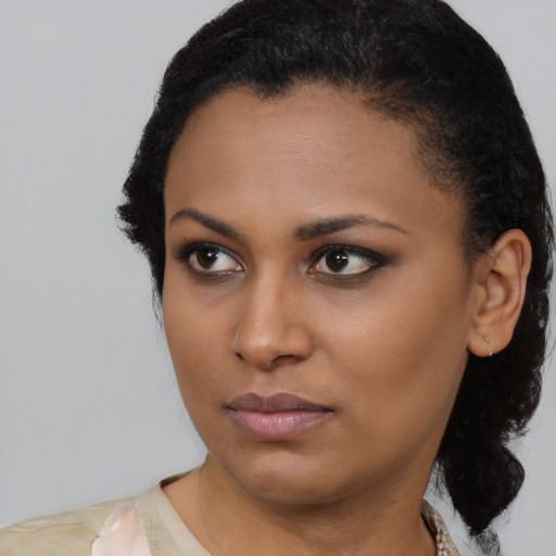 Neutral black young-adult female with medium  black hair and brown eyes