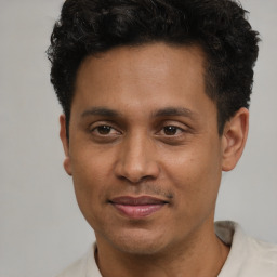 Joyful latino young-adult male with short  brown hair and brown eyes