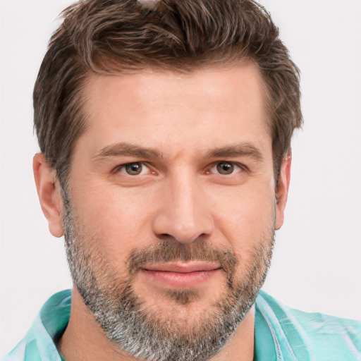 Joyful white adult male with short  brown hair and grey eyes