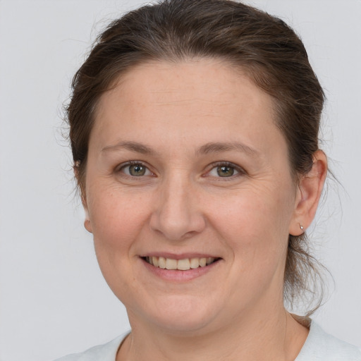 Joyful white adult female with medium  brown hair and brown eyes