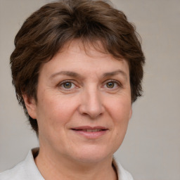 Joyful white adult female with short  brown hair and brown eyes