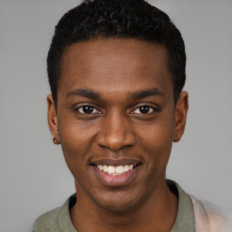 Joyful black young-adult male with short  black hair and brown eyes