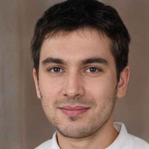 Joyful white young-adult male with short  brown hair and brown eyes