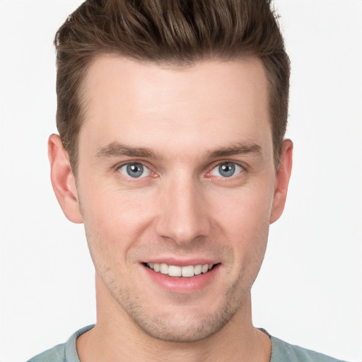 Joyful white young-adult male with short  brown hair and grey eyes