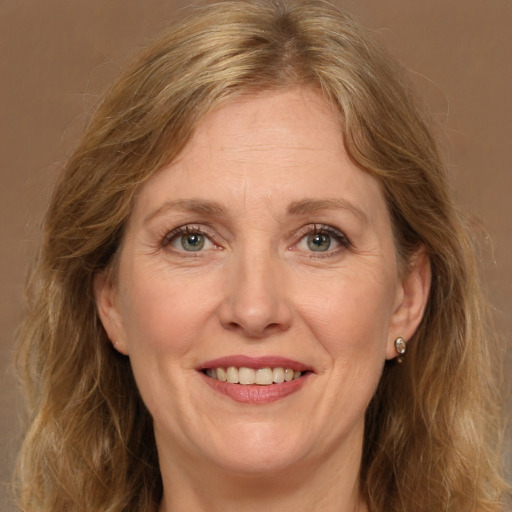 Joyful white adult female with long  brown hair and green eyes