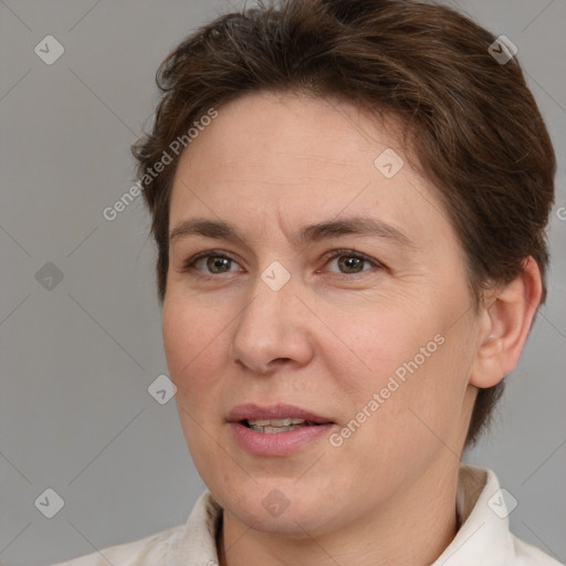 Joyful white adult female with short  brown hair and brown eyes