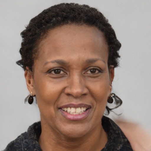 Joyful black adult female with short  brown hair and brown eyes