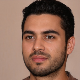Joyful white young-adult male with short  black hair and brown eyes