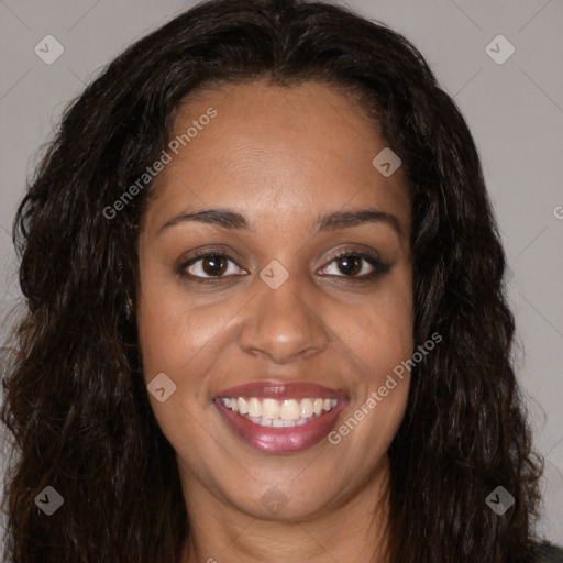 Joyful black young-adult female with long  brown hair and brown eyes