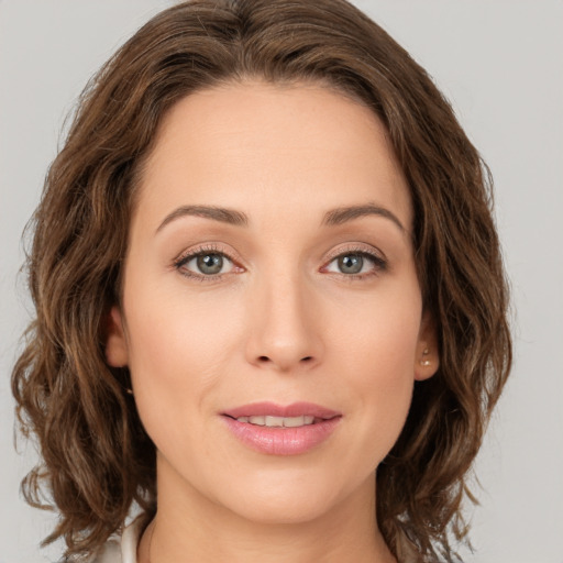 Joyful white young-adult female with medium  brown hair and green eyes