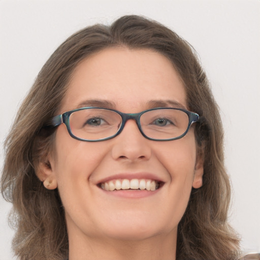 Joyful white young-adult female with long  brown hair and grey eyes