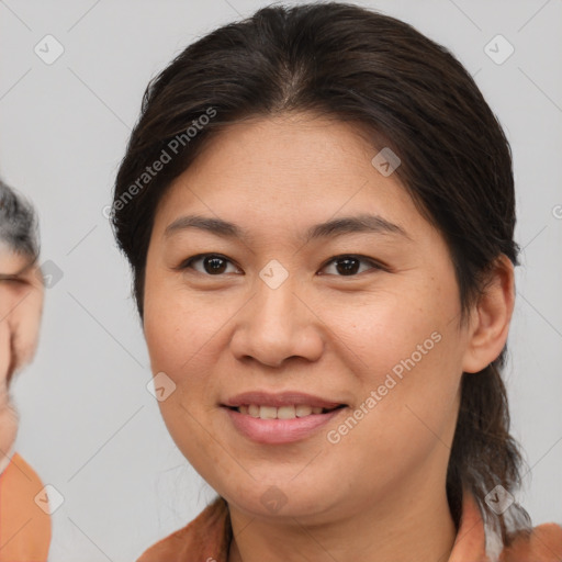 Joyful asian adult female with medium  brown hair and brown eyes