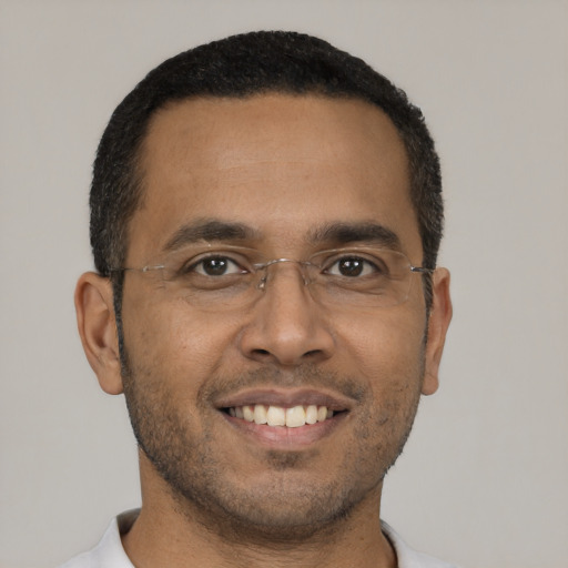 Joyful black young-adult male with short  black hair and brown eyes