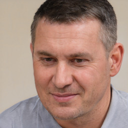 Joyful white adult male with short  brown hair and brown eyes