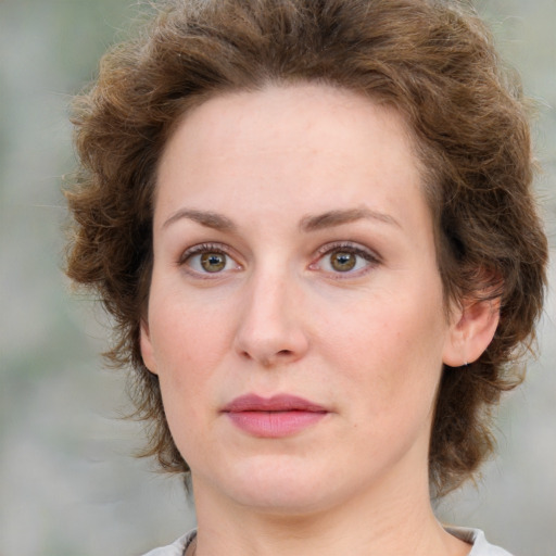 Joyful white young-adult female with medium  brown hair and green eyes