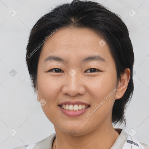 Joyful asian young-adult female with medium  brown hair and brown eyes