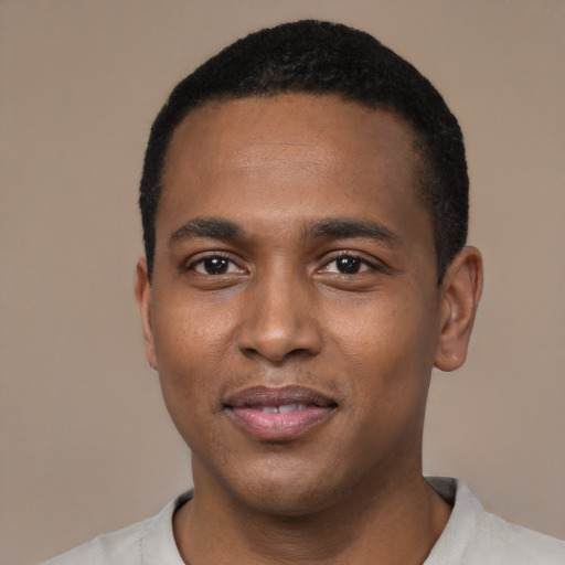 Joyful black young-adult male with short  black hair and brown eyes