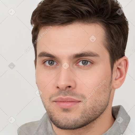 Neutral white young-adult male with short  brown hair and brown eyes