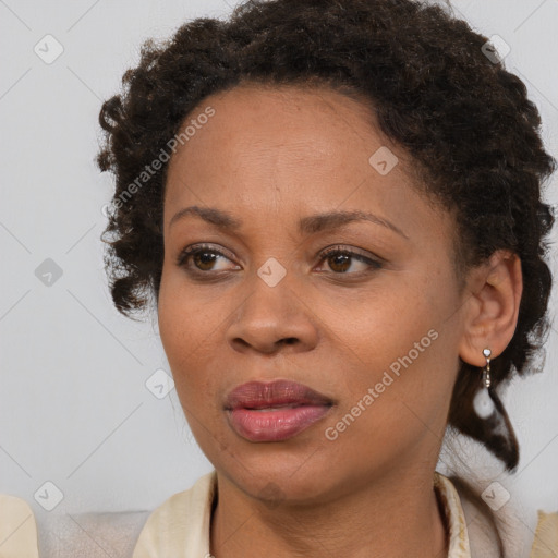 Joyful black adult female with short  brown hair and brown eyes