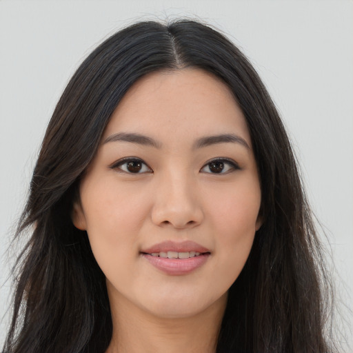 Joyful asian young-adult female with long  brown hair and brown eyes