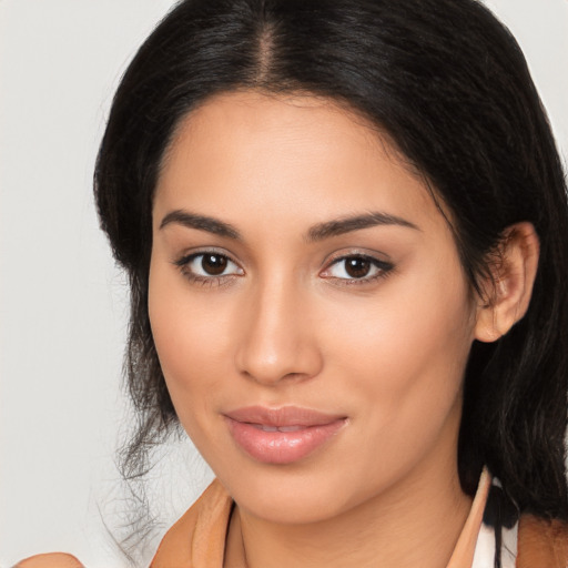 Joyful latino young-adult female with long  brown hair and brown eyes