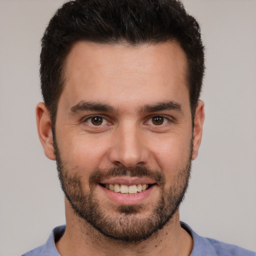 Joyful white young-adult male with short  brown hair and brown eyes