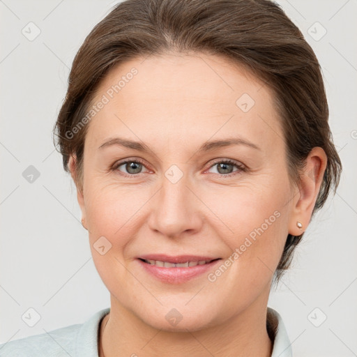 Joyful white adult female with medium  brown hair and grey eyes