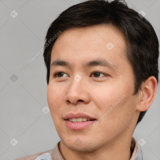 Joyful asian young-adult male with short  brown hair and brown eyes